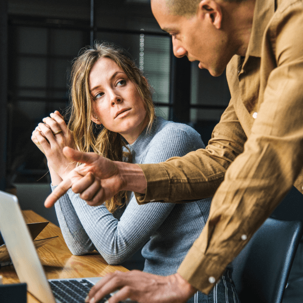 Expert guidance - consultant explaining website optimisation strategies to a client at a desk.